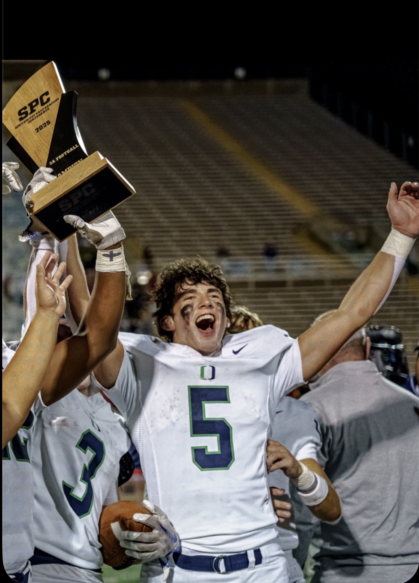 Luke Dearman celebrating with state championship trophy